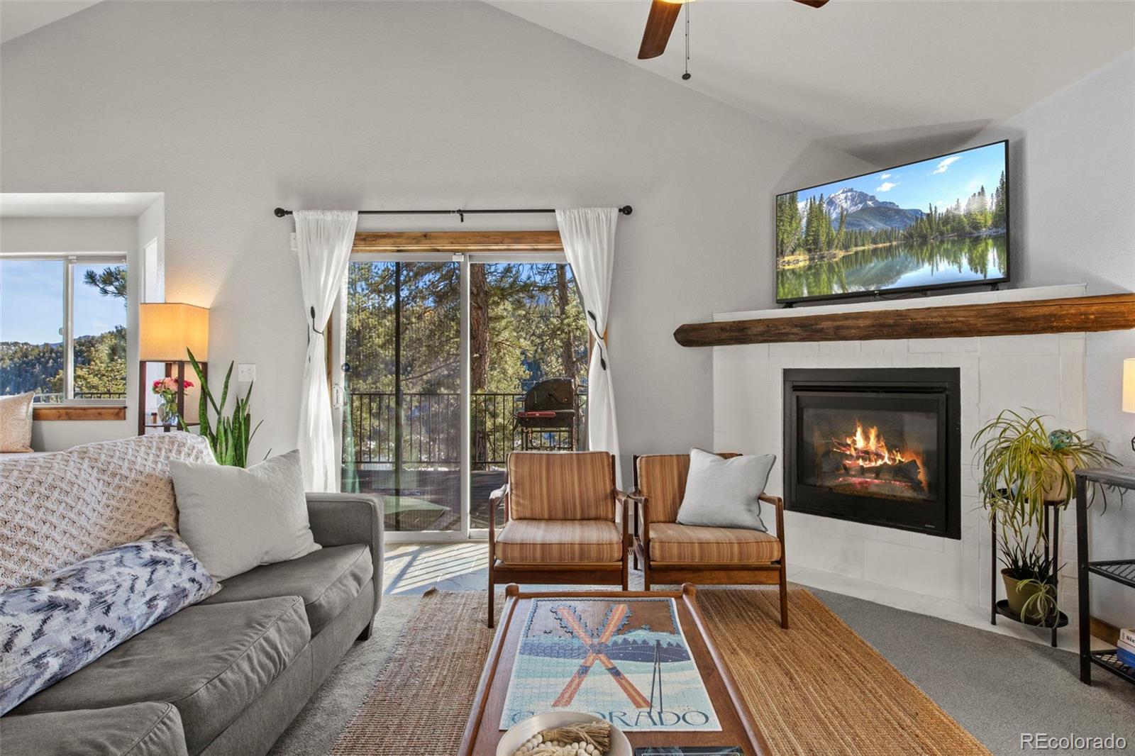 200 Virginia Road Bailey, CO 80421 - Photo 4 of 49 a living room with furniture and a fireplace