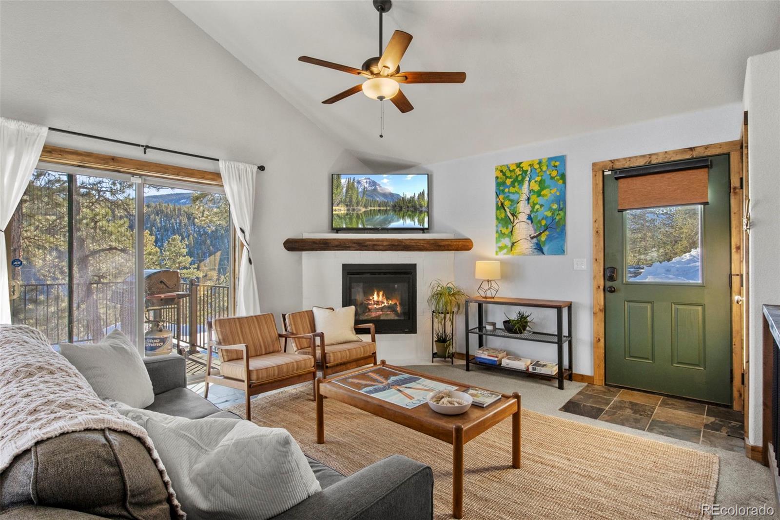 200 Virginia Road Bailey, CO 80421 - Photo 5 of 49 a living room with furniture a fireplace and a floor to ceiling window