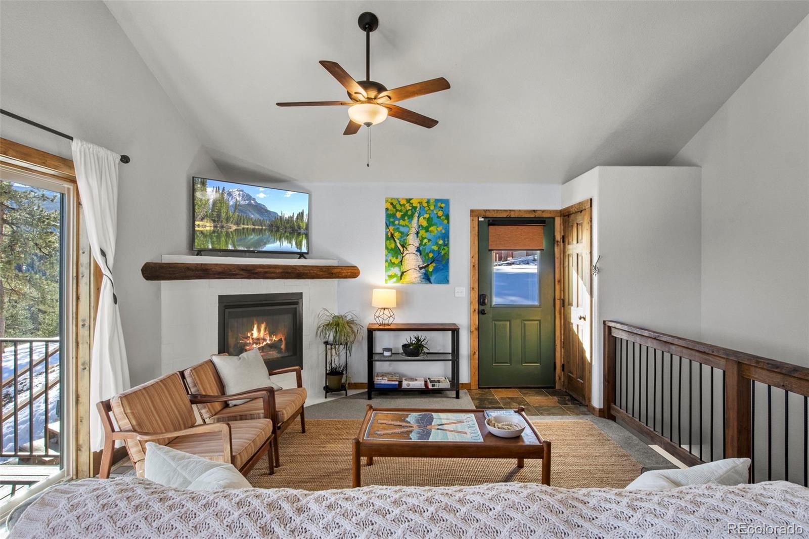 200 Virginia Road Bailey, CO 80421 - Photo 7 of 49 a living room with furniture and a fireplace