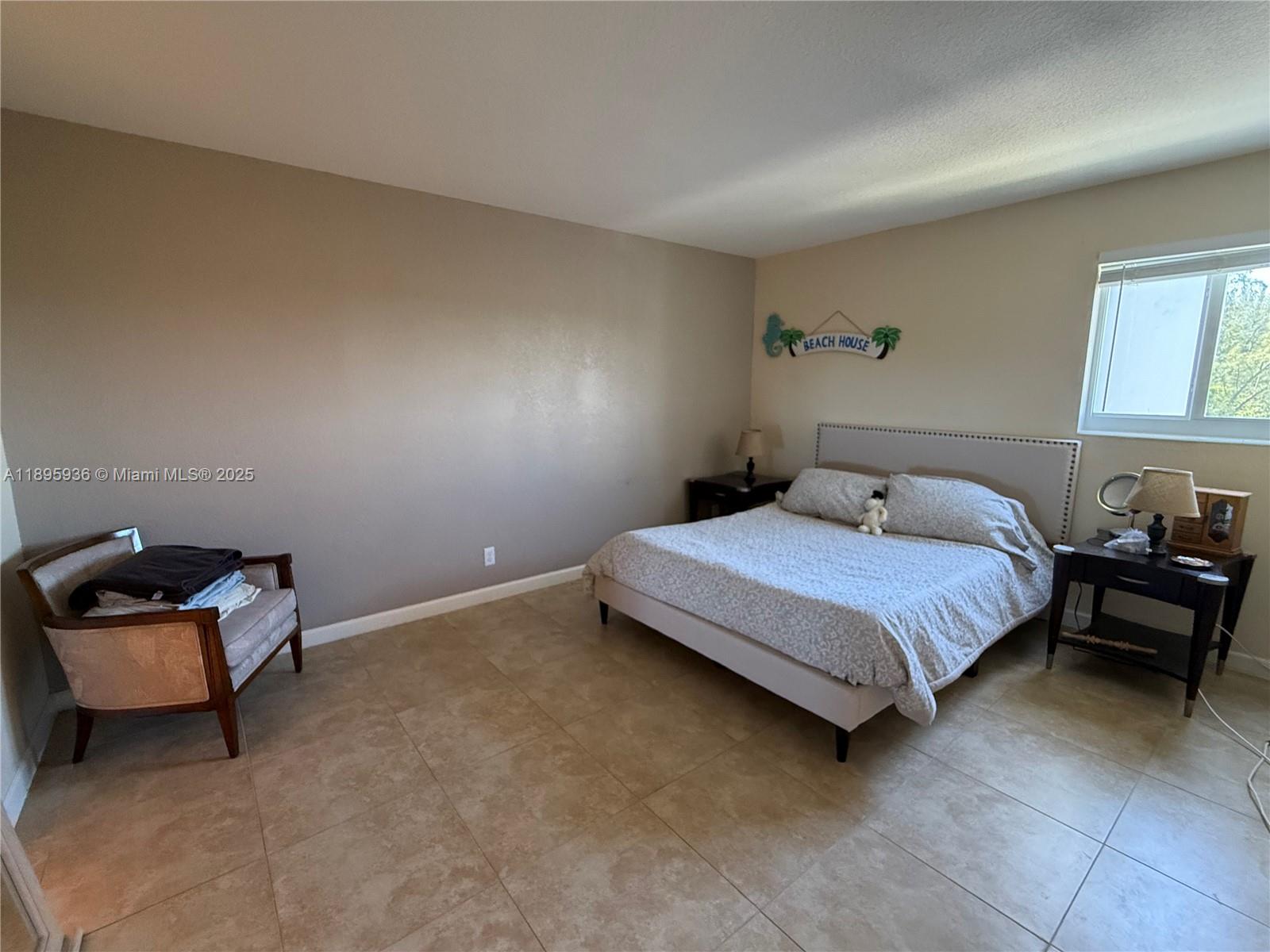 2860 Northeast 14th Street Causeway, Unit 406D Pompano Beach, FL 33062 - Photo 14 of 25 a bedroom with a bed and a window