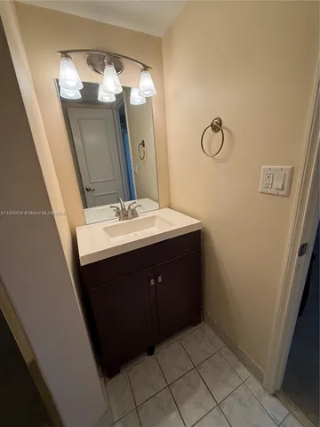 a bathroom with a sink vanity and mirror