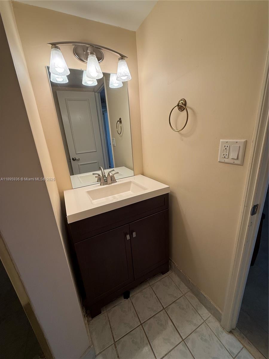 2860 Northeast 14th Street Causeway, Unit 406D Pompano Beach, FL 33062 - Photo 15 of 25 a bathroom with a sink vanity and mirror