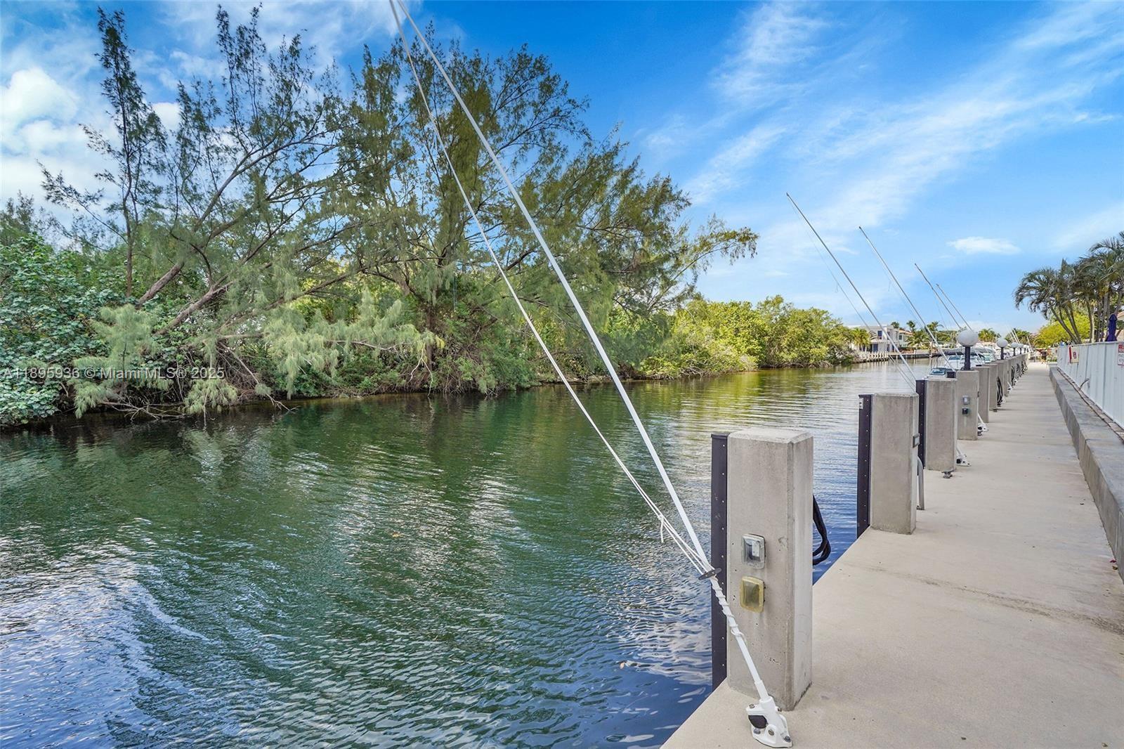 2860 Northeast 14th Street Causeway, Unit 406D Pompano Beach, FL 33062 - Photo 20 of 25 a view of a lake with a yard
