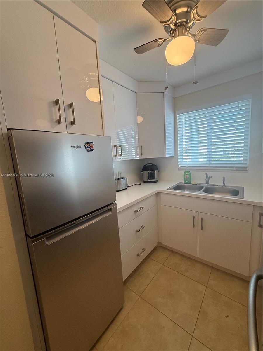 2860 Northeast 14th Street Causeway, Unit 406D Pompano Beach, FL 33062 - Photo 2 of 25 a kitchen with a refrigerator a sink and dishwasher