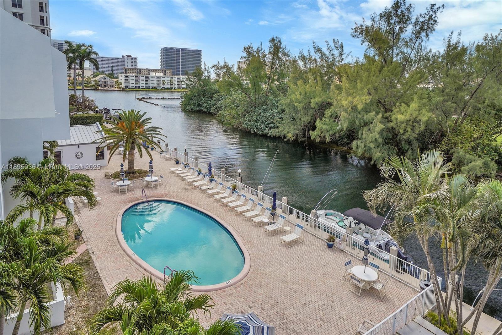 2860 Northeast 14th Street Causeway, Unit 406D Pompano Beach, FL 33062 - Photo 24 of 25 an aerial view of a house with swimming pool and lake view
