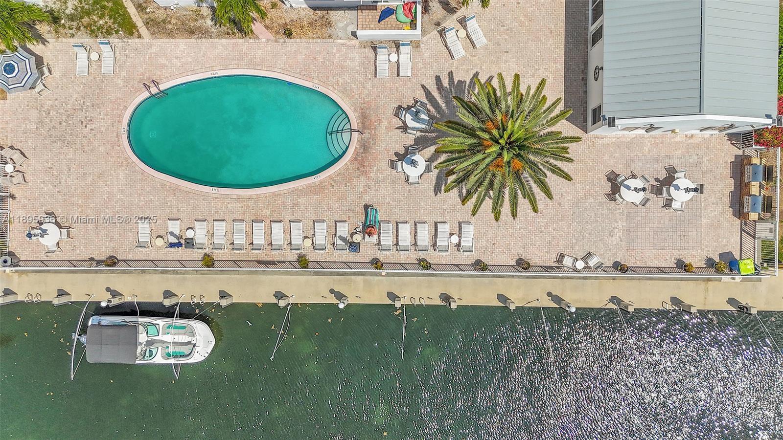 2860 Northeast 14th Street Causeway, Unit 406D Pompano Beach, FL 33062 - Photo 25 of 25 a view of a swimming pool with an outdoor seating