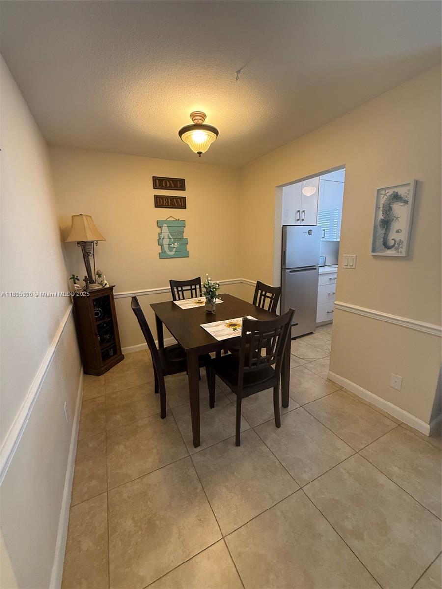 2860 Northeast 14th Street Causeway, Unit 406D Pompano Beach, FL 33062 - Photo 5 of 25 a view of a dining room with furniture