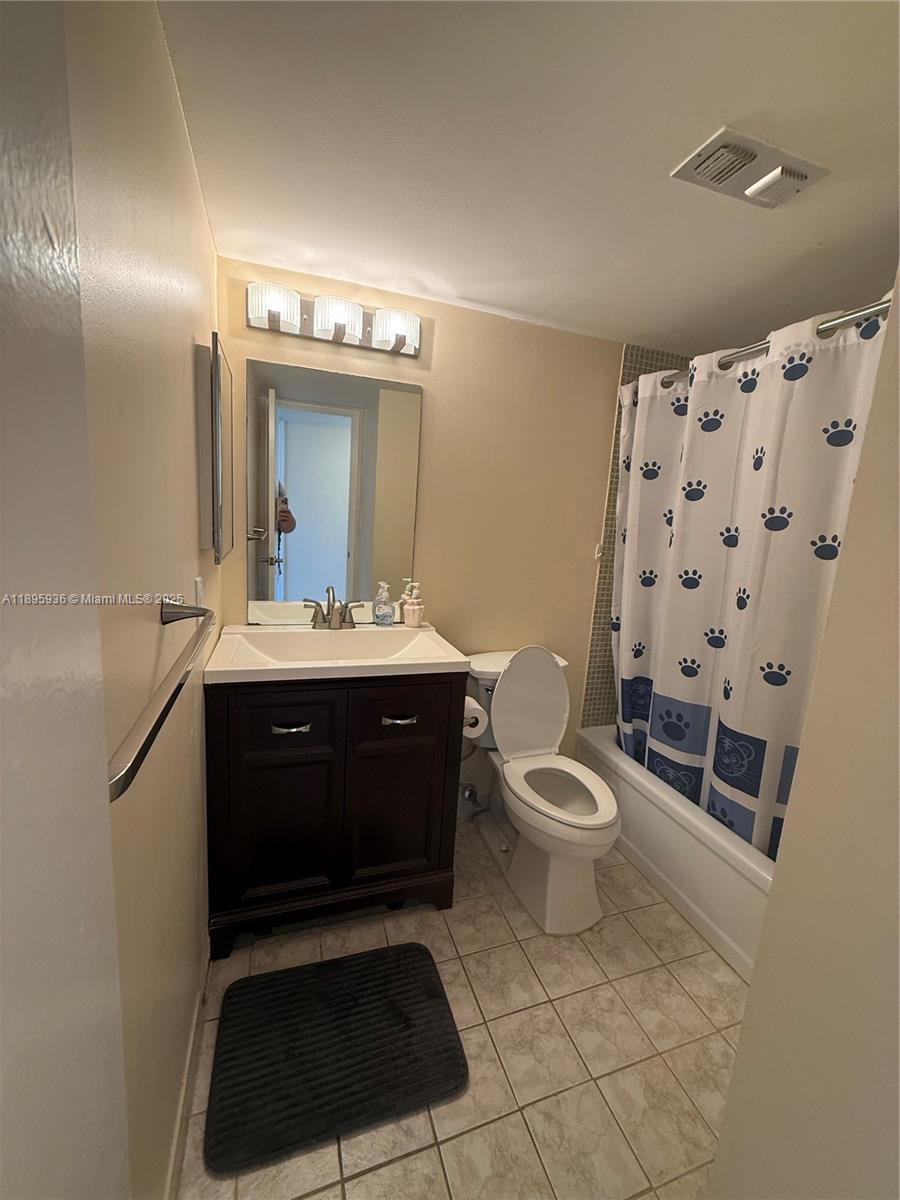2860 Northeast 14th Street Causeway, Unit 406D Pompano Beach, FL 33062 - Photo 8 of 25 a bathroom with a sink a toilet and shower