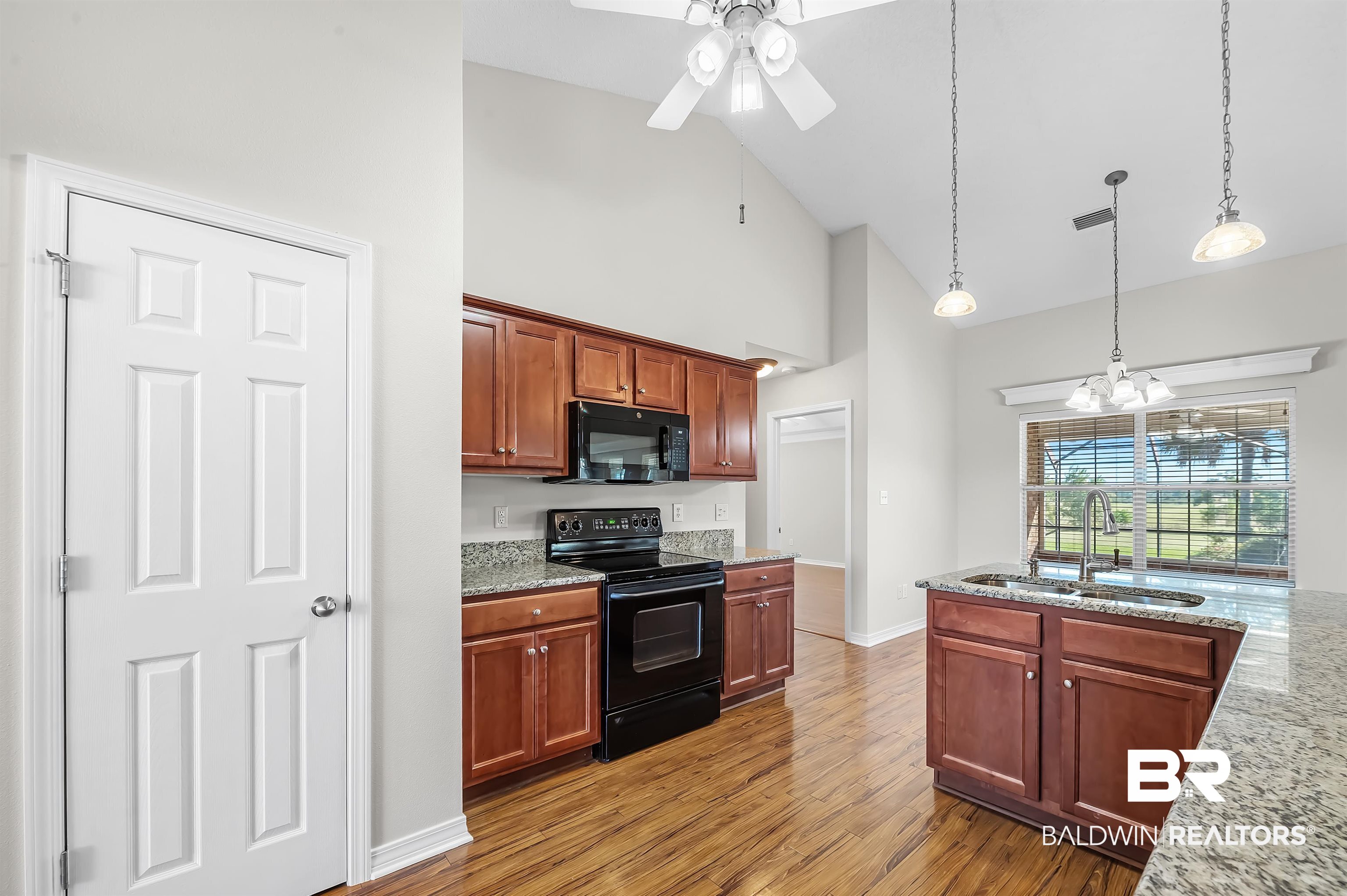 421 Collinwood Loop Foley, AL 36535 - Photo 31 of 62 Kitchen with wood-type flooring, sink, black appliances, pendant lighting, and high vaulted ceiling