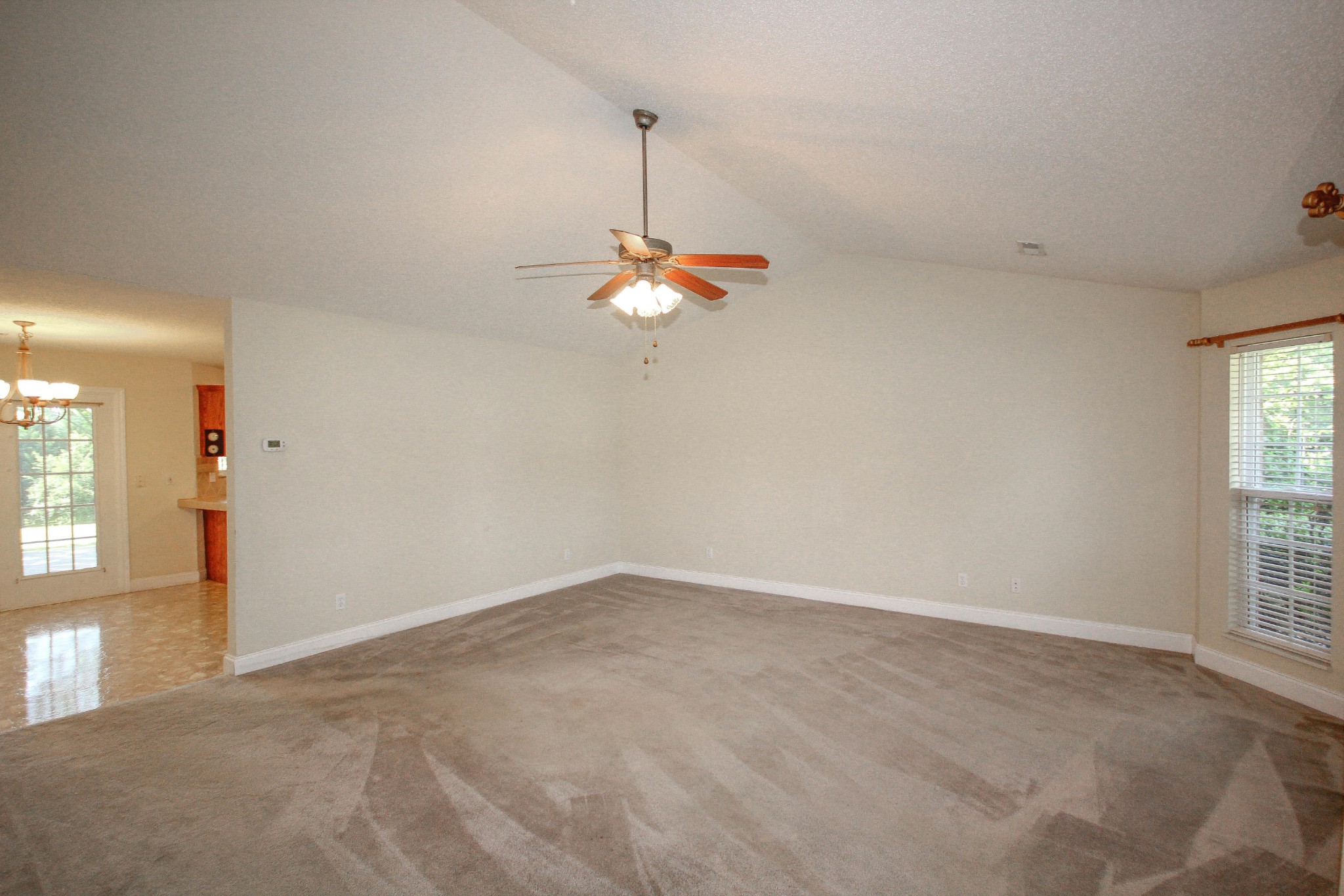 5510 J Riley W Drive Greenback, TN 37742 - Photo 11 of 40 an empty room with windows and chandelier