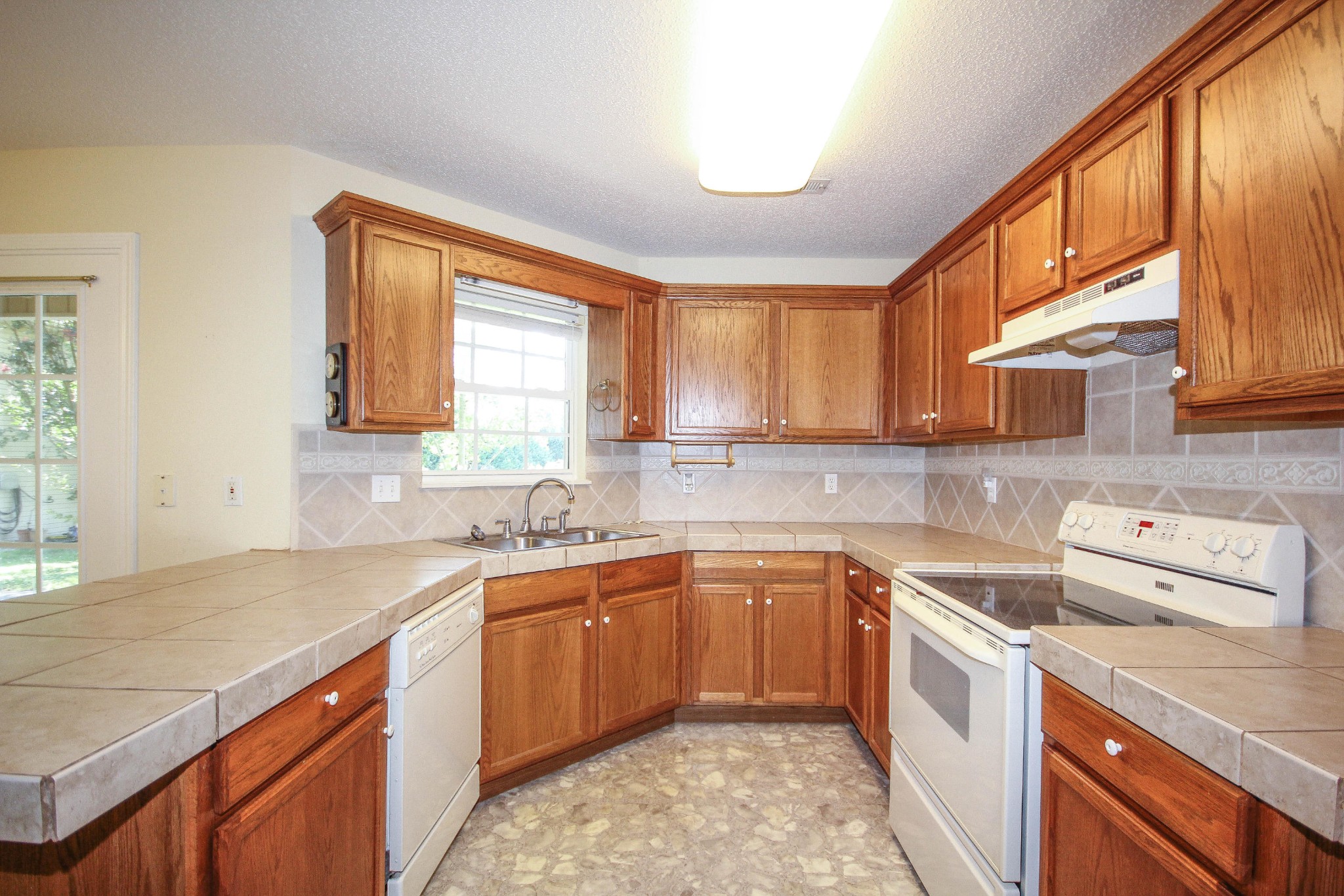 5510 J Riley W Drive Greenback, TN 37742 - Photo 16 of 40 a kitchen with a sink stove and cabinets