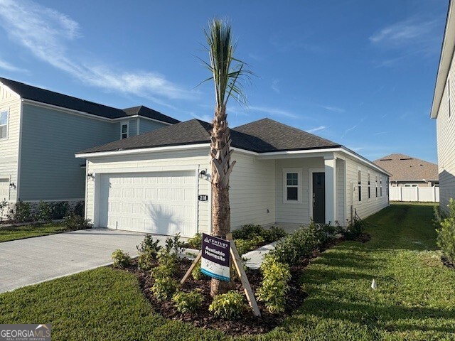 210 Collin Nicholas Drive Kingsland, GA 31548 - Photo 2 of 15 a front view of a house with garden