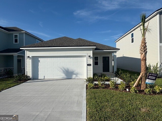 210 Collin Nicholas Drive Kingsland, GA 31548 - Photo 4 of 15 a front view of a house with garden