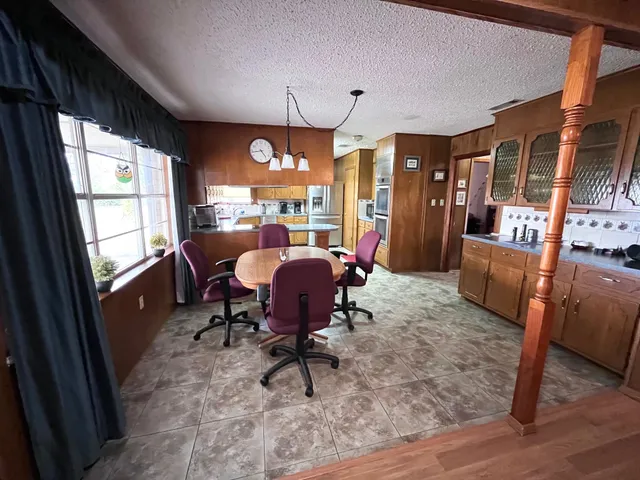 a view of a livingroom with furniture and a window