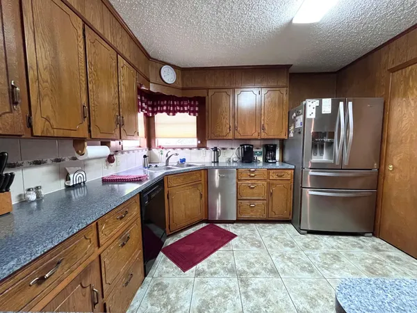 a kitchen with a sink stove and refrigerator