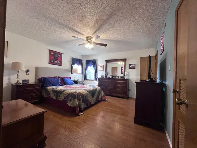 a spacious bedroom with a bed and a chandelier
