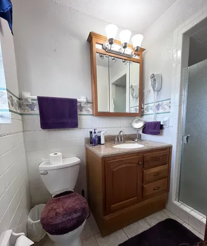 a bathroom with a toilet a sink and a mirror