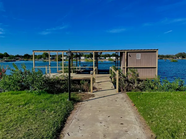 a view of a patio with plants and lake view