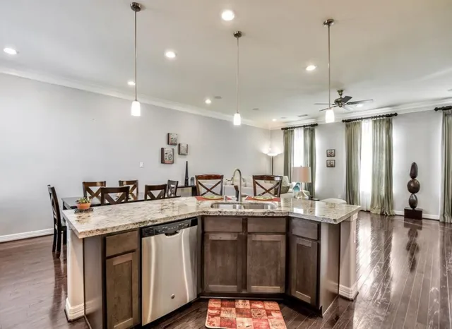 a kitchen with center island a sink appliances and a counter top space
