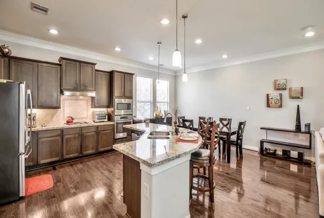 a kitchen with sink refrigerator and cabinets