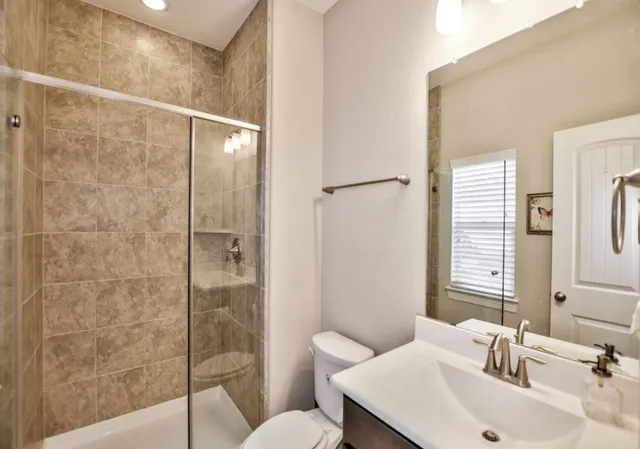 a bathroom with a sink toilet and shower