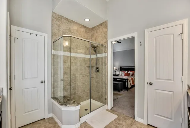 a bathroom that has a glass shower door