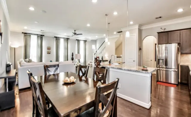 a large kitchen with a table and chairs