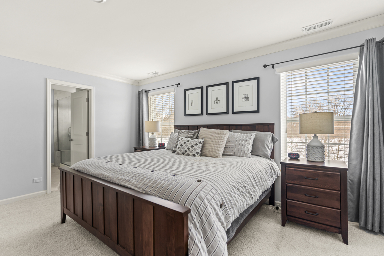 1241 Draper Road McHenry, IL 60050 - Photo 11 of 27 a bedroom with a bed a mirror and a dresser