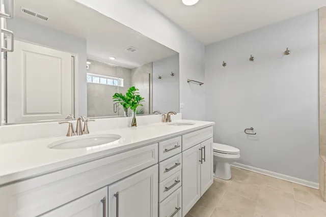 a bathroom with a double vanity sink and a mirror