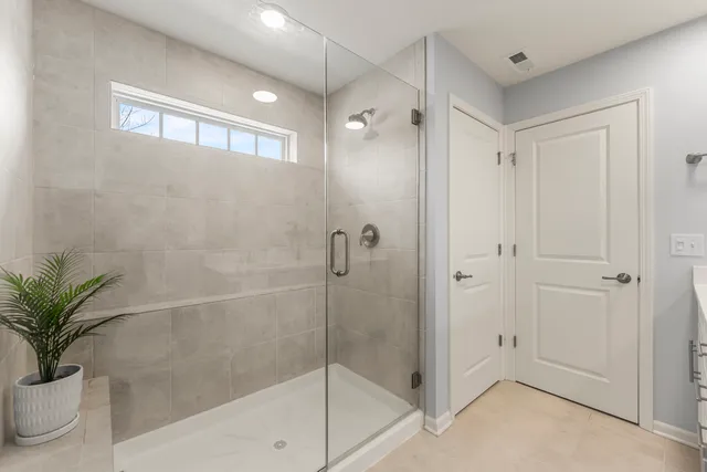 a bathroom with a shower and a sink