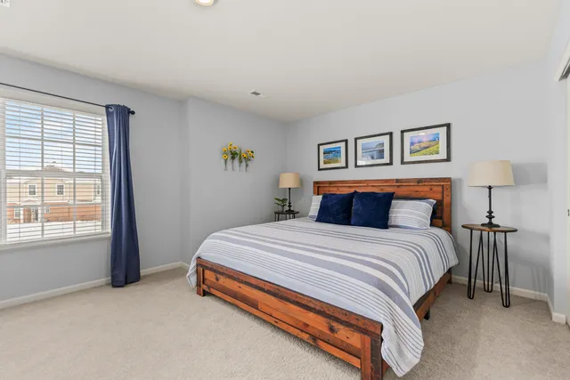 a spacious bedroom with a bed and a window