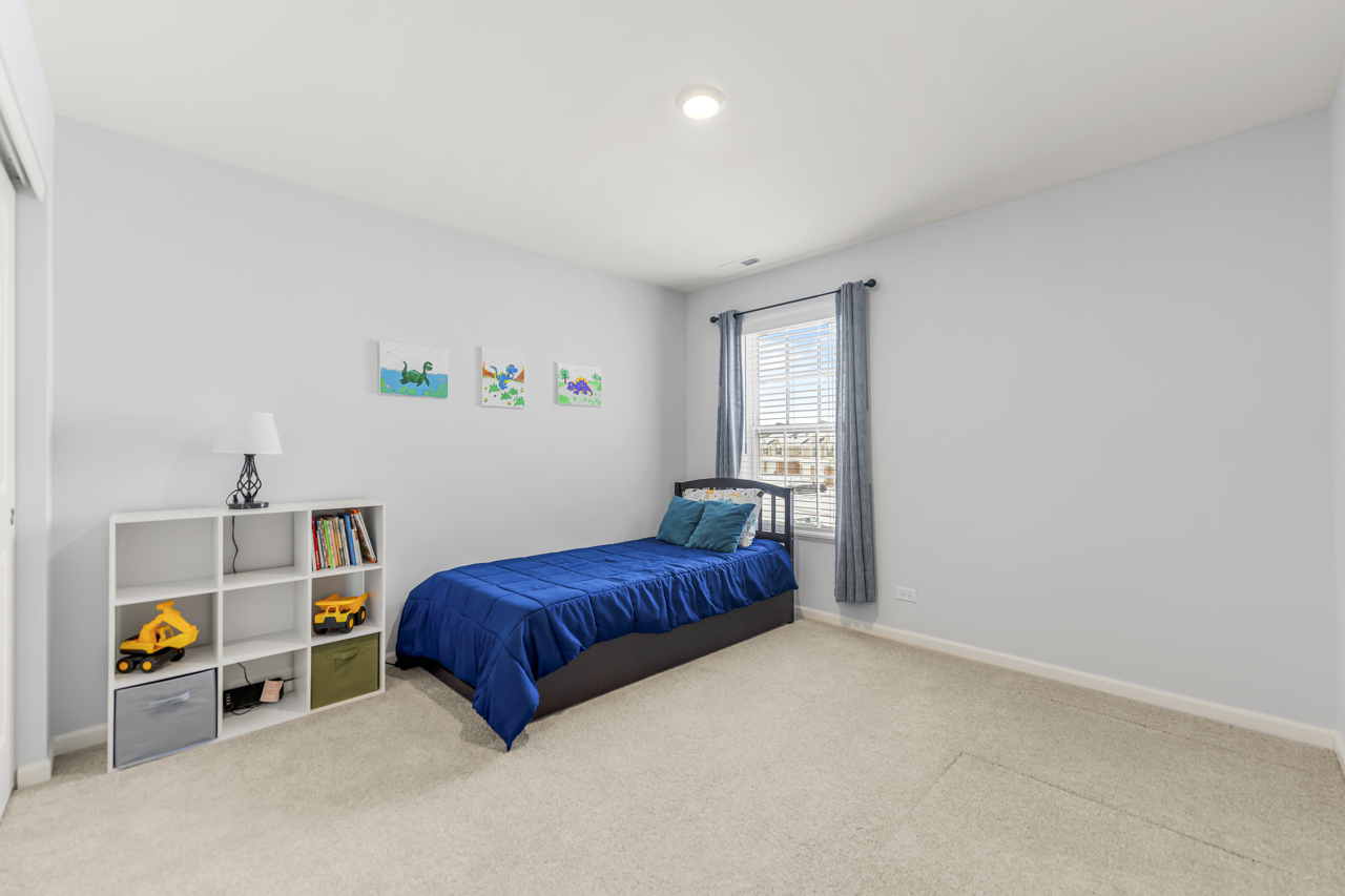 1241 Draper Road McHenry, IL 60050 - Photo 18 of 27 a bedroom with a bed and a window