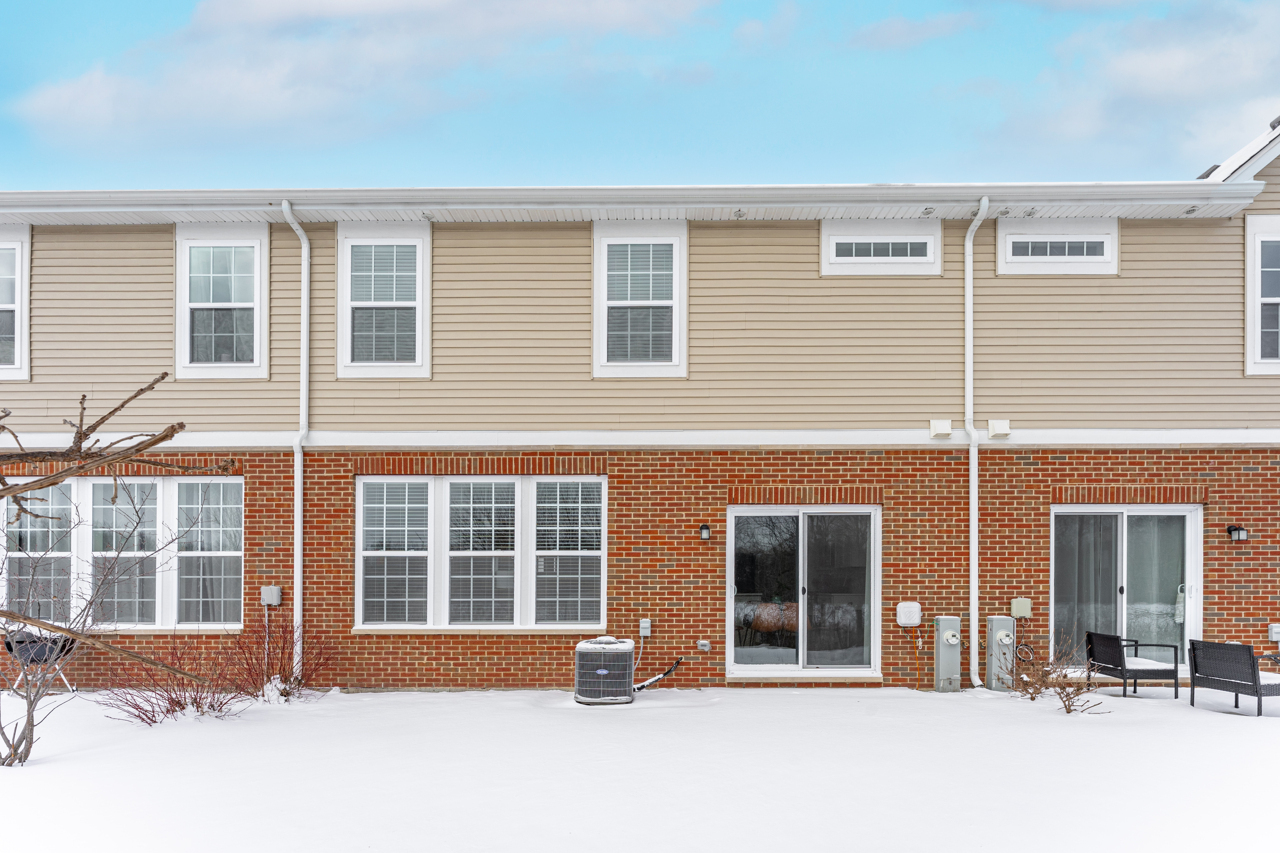 1241 Draper Road McHenry, IL 60050 - Photo 22 of 27 front view of a brick house with large windows