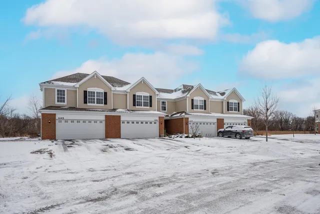 a view of a house with a yard covered with snow in front of house