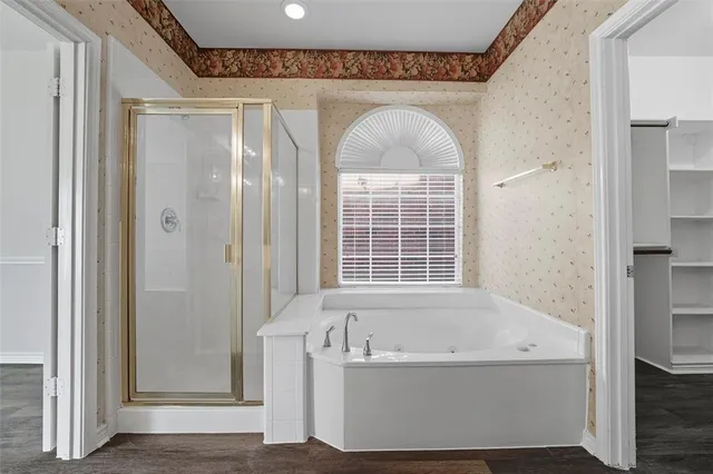 a bathroom with a bathtub and a shower