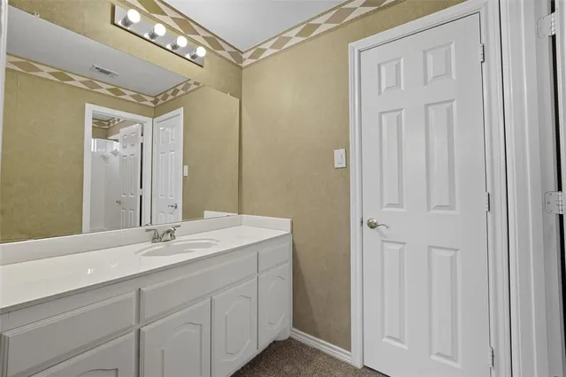 a bathroom with a double vanity sink and a mirror