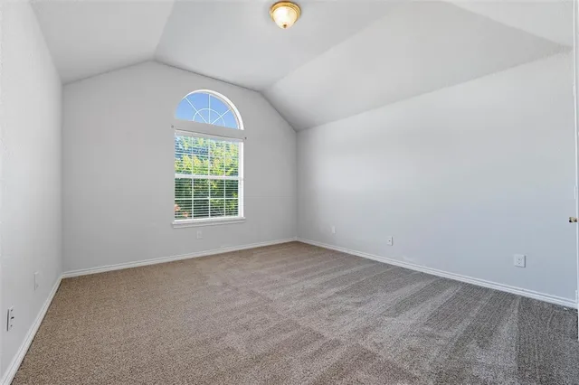 an empty room with windows and mirror