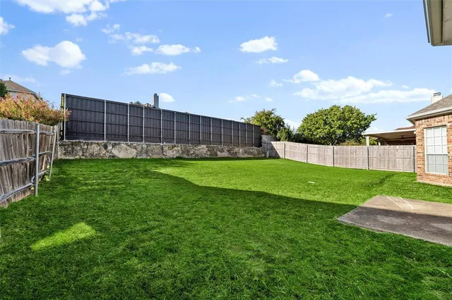 a view of a backyard with a garden and plants