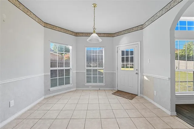 a view of an empty room with windows