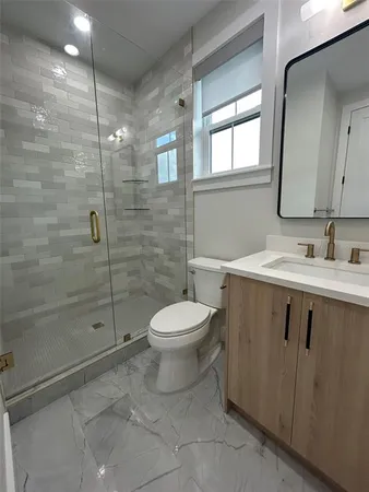 a bathroom with a sink toilet and shower