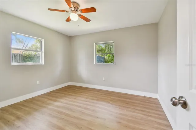 a view of empty room with wooden floor