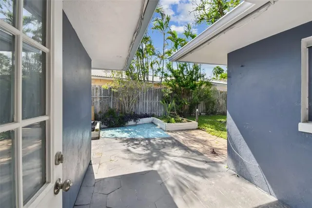 a view of a yard with potted plants
