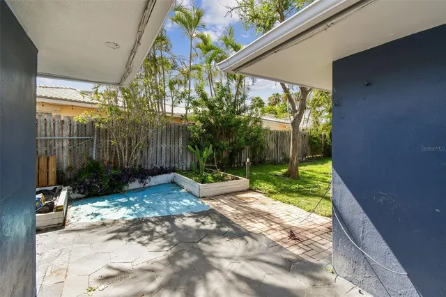 a view of backyard with plants and garden