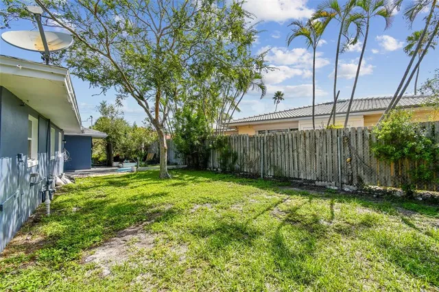 a view of a backyard with a tree
