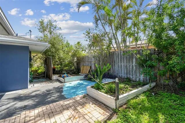 a view of a garden with wooden fence