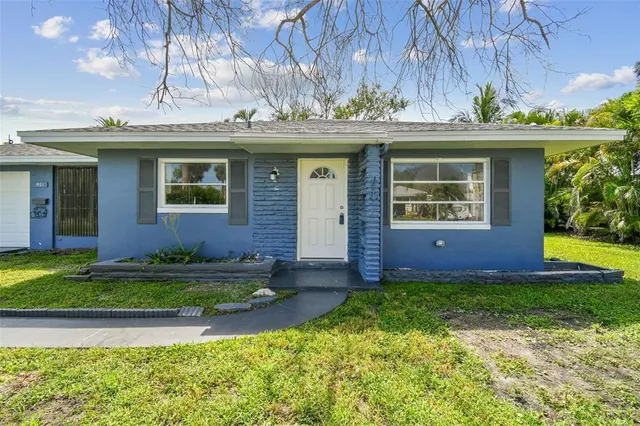 a view of a house with a yard and plants