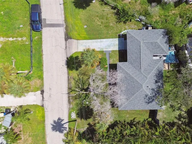 a aerial view of a house with yard swimming pool and outdoor seating