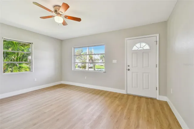 wooden floor in an empty room with a window