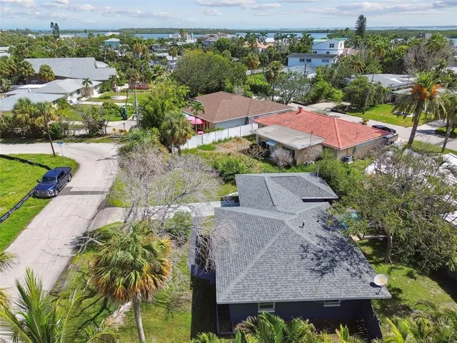 an aerial view of lake and residential houses with outdoor space