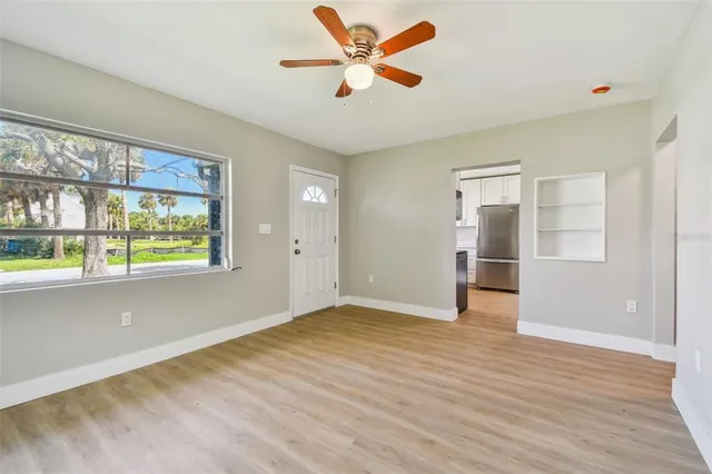 wooden floor in an empty room with a window